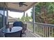 Relaxing covered back porch with outdoor seating, a ceiling fan, and views of lush trees at 514 Creekshire Cir, Canton, GA 30115