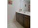 Bathroom with a single sink vanity, tile floor, and floral shower curtain at 514 Creekshire Cir, Canton, GA 30115