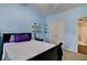 This spacious bedroom with blue walls features a large bed, floating shelves, and an attached bathroom at 514 Creekshire Cir, Canton, GA 30115