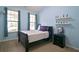 This bedroom offers natural light, neutral carpet, and a black bedside table at 514 Creekshire Cir, Canton, GA 30115