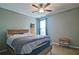 This bedroom offers great natural light, ceiling fan, and attached closet at 514 Creekshire Cir, Canton, GA 30115