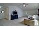 A large bonus room with ample living space includes a bed, sitting area, and neutral carpeting at 514 Creekshire Cir, Canton, GA 30115