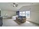 A large bonus room with natural light features a bed, sitting area, and large windows at 514 Creekshire Cir, Canton, GA 30115
