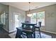 Cozy breakfast nook features natural light, hardwood floors, a hanging light fixture, and views of the backyard at 514 Creekshire Cir, Canton, GA 30115