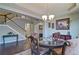 Dining room with staircase, chandelier, glass table, and elegant decor at 514 Creekshire Cir, Canton, GA 30115