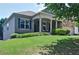 Inviting front exterior showcasing lush green grass, mature landscaping, and a covered front porch at 514 Creekshire Cir, Canton, GA 30115