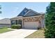 Attractive home with a stone and siding facade, attached garage, and a neatly maintained front yard at 514 Creekshire Cir, Canton, GA 30115