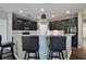 This kitchen features granite countertops, dark cabinets, stainless steel appliances, and barstool seating at 514 Creekshire Cir, Canton, GA 30115