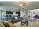 Open-concept living room featuring a ceiling fan, barstool seating, and access to the dining area at 514 Creekshire Cir, Canton, GA 30115