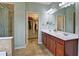 This main bathroom offers dual sinks, walk in shower, walk in closet access, and ceramic tile at 514 Creekshire Cir, Canton, GA 30115