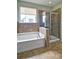 This main bathroom features a separate tub and walk-in shower with ceramic tile flooring at 514 Creekshire Cir, Canton, GA 30115