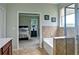 This main bathroom offers tub and shower access and view into the main bedroom at 514 Creekshire Cir, Canton, GA 30115