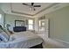 The main bedroom features an ensuite bathroom, neutral paint and carpet, and a ceiling fan at 514 Creekshire Cir, Canton, GA 30115