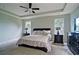 This main bedroom boasts natural light, tray ceiling, and is finished with neutral paint and carpet at 514 Creekshire Cir, Canton, GA 30115
