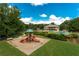 Neighborhood playground with slides and equipment, surrounded by lush greenery and a view of the community pool at 514 Creekshire Cir, Canton, GA 30115