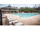 Large community swimming pool with lounge chairs and a two-story building and recreational area at 514 Creekshire Cir, Canton, GA 30115