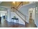 Foyer view of staircase with hardwood floors and white trim at 514 Creekshire Cir, Canton, GA 30115