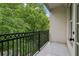 View of the trees from the balcony with a decorative black wrought iron railing and neutral colors at 11 Perimeter E Ctr # 1402, Dunwoody, GA 30346