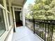 Relaxing balcony with black iron railing and beautiful green trees surrounding the exterior at 11 Perimeter E Ctr # 1402, Dunwoody, GA 30346
