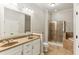 Bathroom features a double vanity, large mirror, tiled floors, glass shower, and soaking tub at 11 Perimeter E Ctr # 1402, Dunwoody, GA 30346