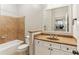 Bathroom with shower and bath combination, toilet, and mirror showing view to kitchen at 11 Perimeter E Ctr # 1402, Dunwoody, GA 30346