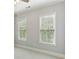 Carpeted bedroom with two large windows featuring a bright green outdoor view at 11 Perimeter E Ctr # 1402, Dunwoody, GA 30346