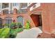 Building entrance and landscaping with a brick wall at 11 Perimeter E Ctr # 1402, Dunwoody, GA 30346
