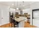 Modern kitchen with granite island, stainless steel appliances, and laundry closet at 11 Perimeter E Ctr # 1402, Dunwoody, GA 30346