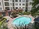 Overhead view of a community pool surrounded by brick pavers and well-manicured landscaping near a multi-story building at 11 Perimeter E Ctr # 1402, Dunwoody, GA 30346