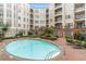 Beautiful pool in a courtyard setting, surrounded by lounge chairs and lush landscaping at 11 Perimeter E Ctr # 1402, Dunwoody, GA 30346