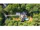 Beautiful home surrounded by lush trees features a long driveway and an inviting backyard pool at 1191 W Conway Dr, Atlanta, GA 30327