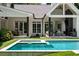 Gorgeous backyard featuring a pool, outdoor dining, living spaces, and lush greenery creating a private retreat at 1191 W Conway Dr, Atlanta, GA 30327