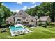 Aerial backyard view of a home with a swimming pool, lush landscaping, seating areas, and a well-manicured lawn at 1191 W Conway Dr, Atlanta, GA 30327