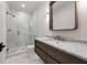 Modern bathroom featuring marble walk-in shower, marble countertop and flooring, with sleek dark wood vanity at 1191 W Conway Dr, Atlanta, GA 30327