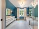 Modern bathroom featuring a soaking tub, glass shower, neutral tile, and large vanity with natural light at 1191 W Conway Dr, Atlanta, GA 30327