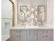 Elegant bathroom with double sinks, gold accents, shower with gold door, and flower shaped sconces at 1191 W Conway Dr, Atlanta, GA 30327