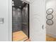 Residential elevator boasts geometric black tile on the walls and light hardwood flooring at 1191 W Conway Dr, Atlanta, GA 30327