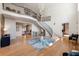 Spacious foyer with curved staircase and chandelier providing an impressive entrance and view into other rooms at 1191 W Conway Dr, Atlanta, GA 30327