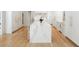 Modern kitchen with a large marble island, white cabinetry, and hardwood floors at 1191 W Conway Dr, Atlanta, GA 30327