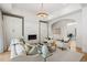 Open-concept living room with hardwood floors, a fireplace, and stylish seating at 1191 W Conway Dr, Atlanta, GA 30327