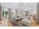 Spacious living room featuring a large sectional sofa, hardwood floors, and backyard views; open-concept to the kitchen at 1191 W Conway Dr, Atlanta, GA 30327