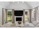 Bright living room with a fireplace, hardwood floors, neutral color palette, and large windows with backyard views at 1191 W Conway Dr, Atlanta, GA 30327