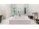 Modern main bathroom featuring a soaking tub, double shower with glass enclosure, and elegant fixtures at 1191 W Conway Dr, Atlanta, GA 30327