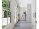 Functional mudroom with gray tile flooring, white cabinetry, and outdoor access at 1191 W Conway Dr, Atlanta, GA 30327