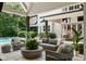 Inviting covered outdoor living area with comfortable seating and lush landscaping at 1191 W Conway Dr, Atlanta, GA 30327