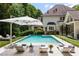 Clear, inviting pool, surrounded by luxurious lounge chairs and a large umbrella, perfect for relaxing and enjoying the sun at 1191 W Conway Dr, Atlanta, GA 30327