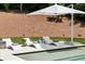 Serene poolside with lounge chairs, a modern umbrella, and lush landscaping, perfect for relaxation and outdoor enjoyment at 1191 W Conway Dr, Atlanta, GA 30327