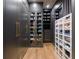 Custom walk-in closet with dark wood cabinets, glass shelving, gold hardware, and organized shoe storage at 1191 W Conway Dr, Atlanta, GA 30327
