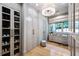 Custom walk-in closet featuring plenty of storage space, built-in shelving, drawers, and stylish lighting at 1191 W Conway Dr, Atlanta, GA 30327