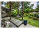 Landscaped backyard with mature trees, a wooden deck, and a hot tub, creating a private outdoor retreat at 1450 Crescent Walk, Decatur, GA 30033